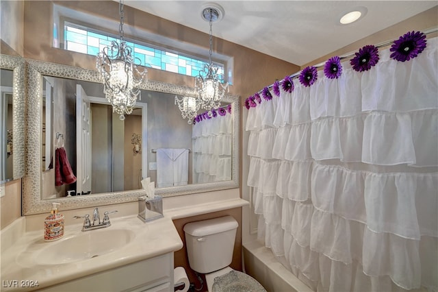 full bathroom with vanity, toilet, shower / tub combo, and an inviting chandelier