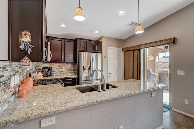 kitchen with decorative backsplash, decorative light fixtures, stainless steel appliances, and sink