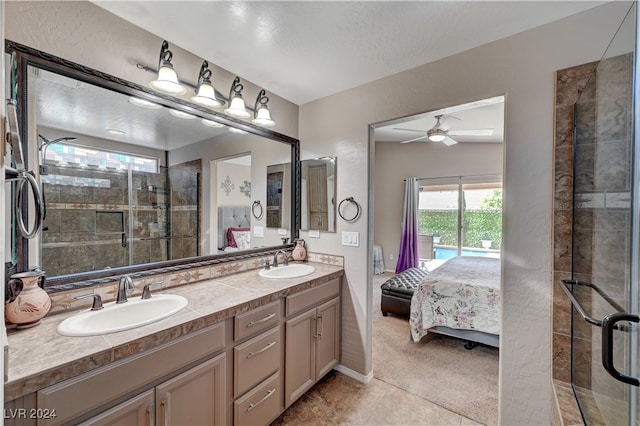 bathroom featuring ceiling fan, a textured ceiling, vanity, an enclosed shower, and tile patterned floors