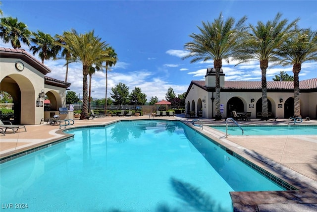 view of swimming pool featuring a patio area