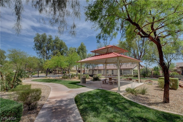 view of property's community with a yard, a gazebo, and a patio