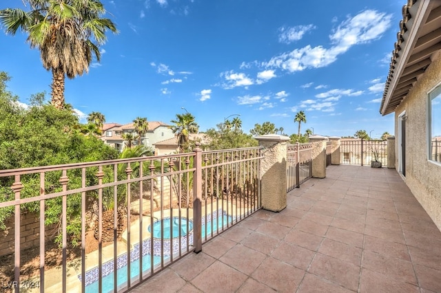 view of patio / terrace featuring a balcony and a fenced in pool