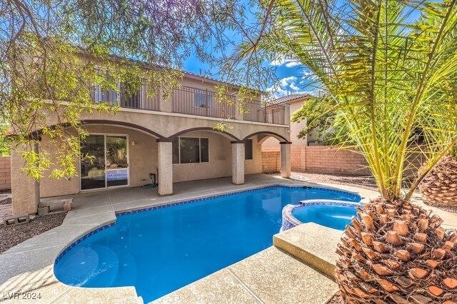 view of swimming pool with a patio area and an in ground hot tub