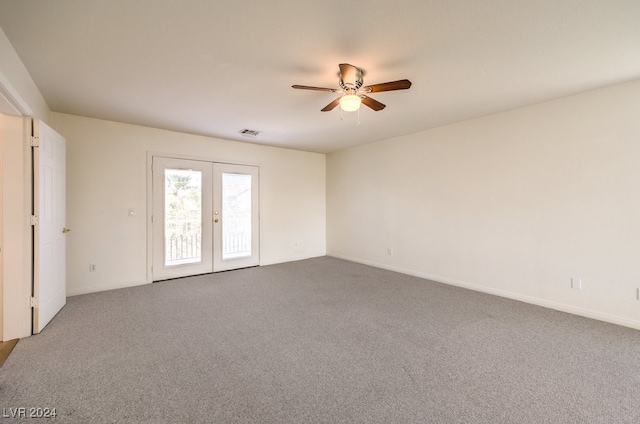 empty room featuring visible vents, baseboards, a ceiling fan, french doors, and carpet