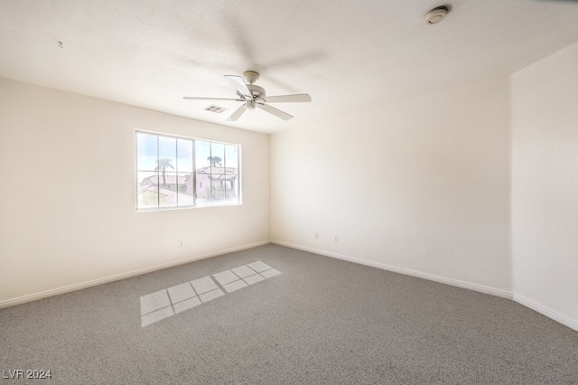 spare room with ceiling fan, carpet flooring, visible vents, and baseboards