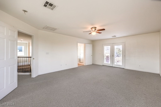 spare room with carpet, french doors, visible vents, and ceiling fan