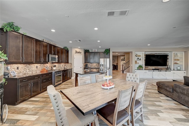 dining area featuring built in shelves and a textured ceiling