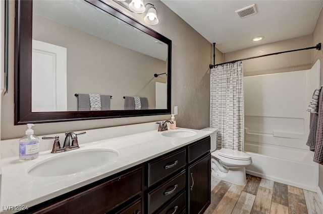 full bathroom with vanity, toilet, wood-type flooring, and shower / bath combo