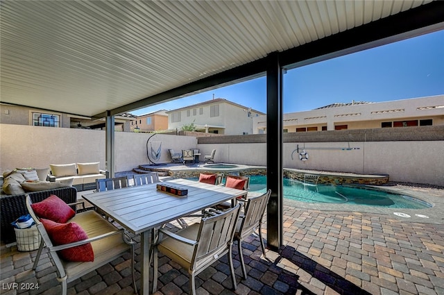 view of patio with an outdoor living space and a pool with hot tub