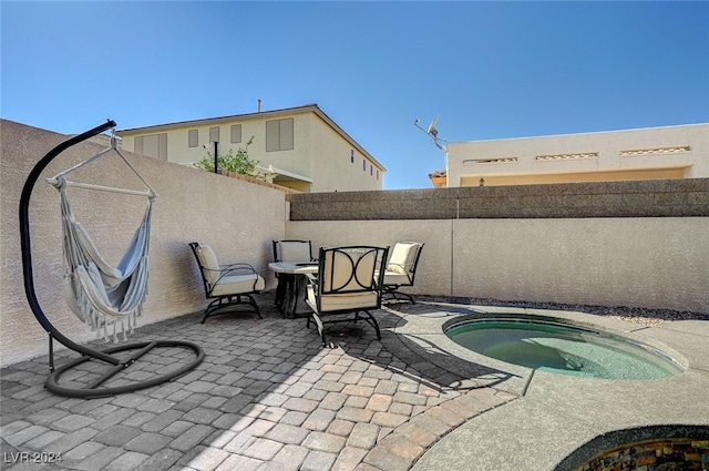 view of patio / terrace featuring an in ground hot tub