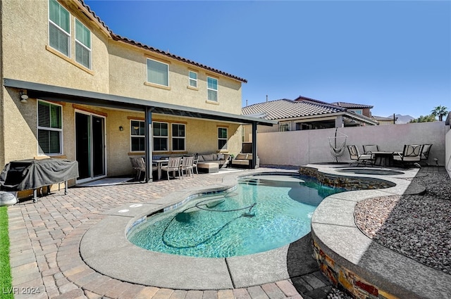 view of pool featuring an outdoor living space, area for grilling, and a patio area