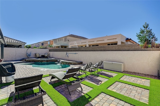 view of pool featuring pool water feature and a patio