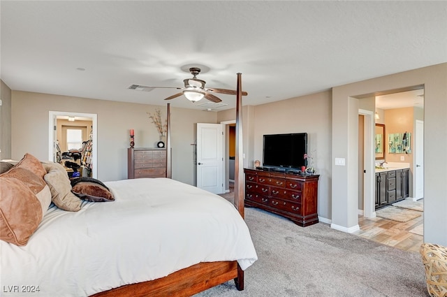 carpeted bedroom featuring a walk in closet, ceiling fan, a closet, and ensuite bath