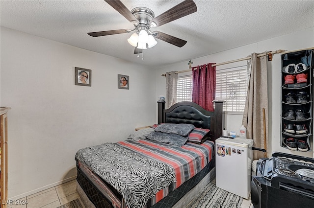 bedroom with light tile patterned flooring, a textured ceiling, and ceiling fan