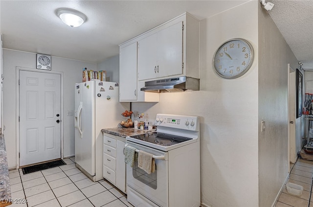 kitchen featuring white cabinetry, a textured ceiling, light tile patterned floors, and white appliances