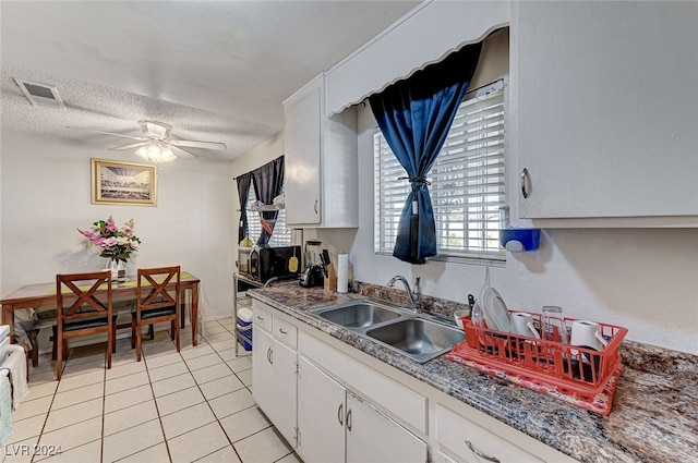 kitchen featuring light tile patterned flooring, sink, a textured ceiling, ceiling fan, and white cabinets