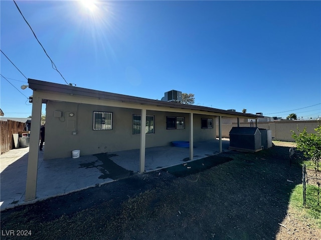 view of home's exterior with a patio area and central AC