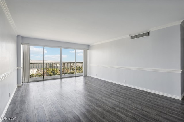 spare room with dark wood-type flooring and ornamental molding