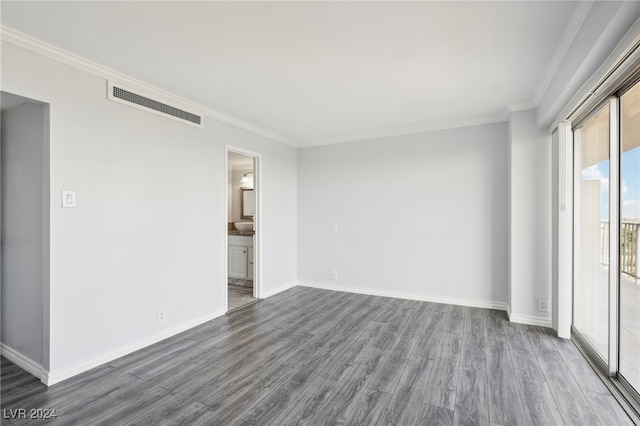 empty room featuring ornamental molding and dark hardwood / wood-style flooring