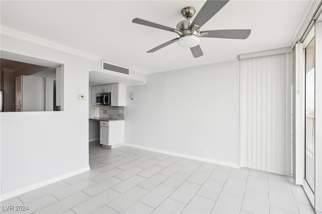 unfurnished living room featuring ceiling fan, ornamental molding, and light tile patterned floors