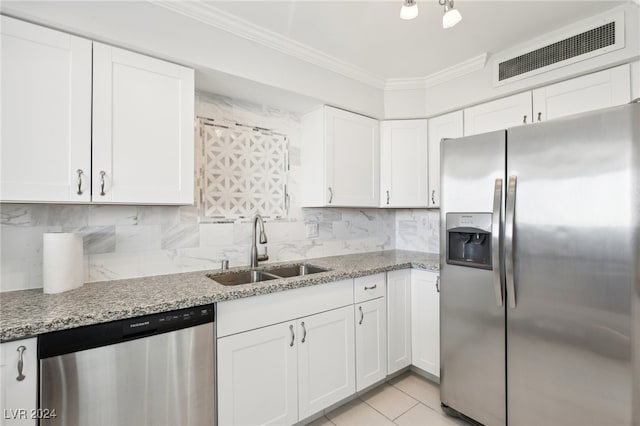 kitchen featuring light stone countertops, sink, white cabinetry, stainless steel appliances, and ornamental molding