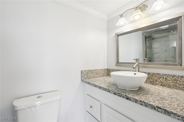 bathroom with vanity, crown molding, toilet, and walk in shower