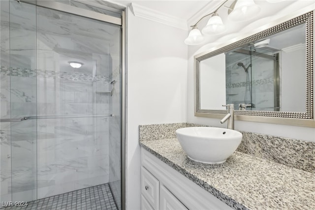 bathroom with vanity, crown molding, a shower with shower door, and tile patterned flooring