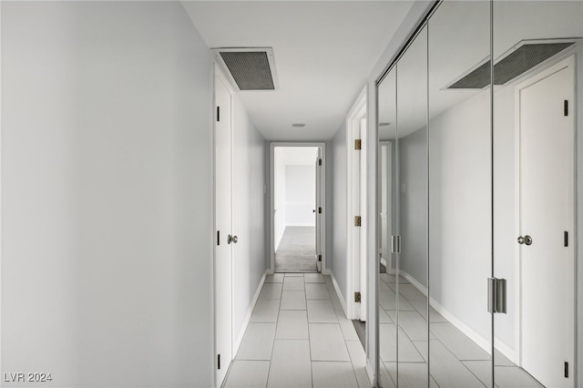 hall featuring light tile patterned floors