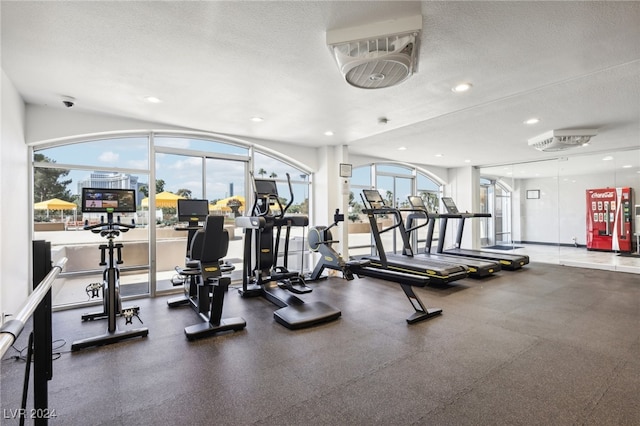 workout area with a wealth of natural light and a textured ceiling