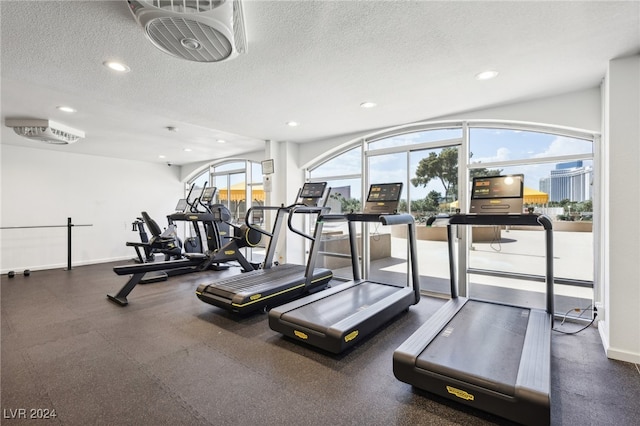 exercise room with a textured ceiling