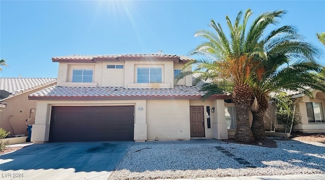 mediterranean / spanish house featuring a garage