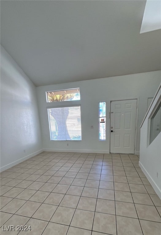 tiled entrance foyer with lofted ceiling