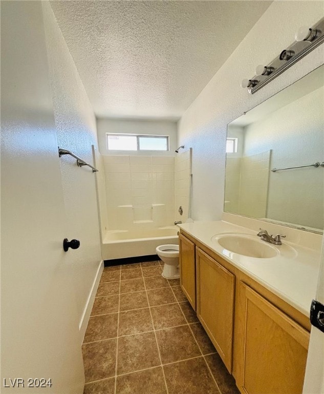 full bathroom with toilet, tile patterned floors, washtub / shower combination, vanity, and a textured ceiling