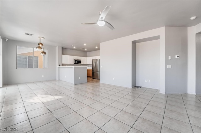 unfurnished living room with light tile patterned floors and ceiling fan