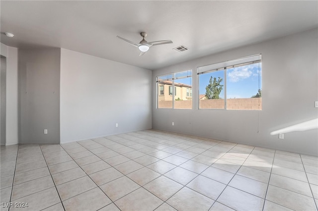 unfurnished room with light tile patterned flooring and ceiling fan