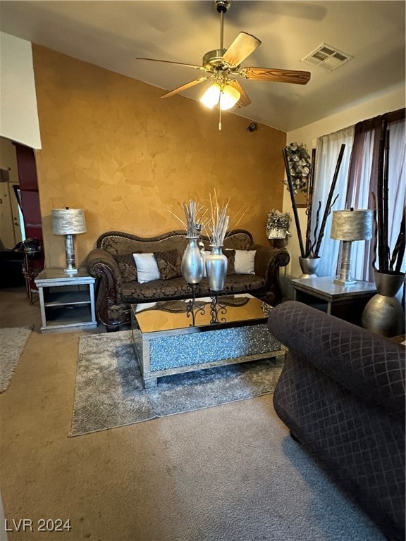 living room featuring ceiling fan, carpet floors, and lofted ceiling