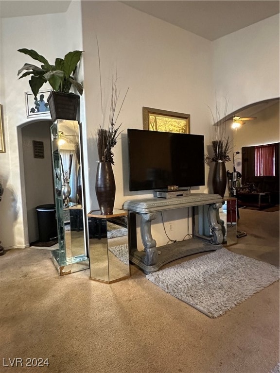 living room with ceiling fan and carpet floors