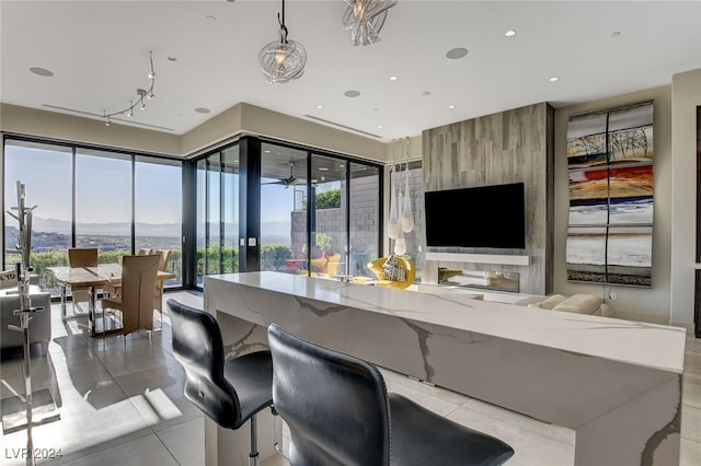 bar with pendant lighting, a mountain view, french doors, and light tile patterned floors