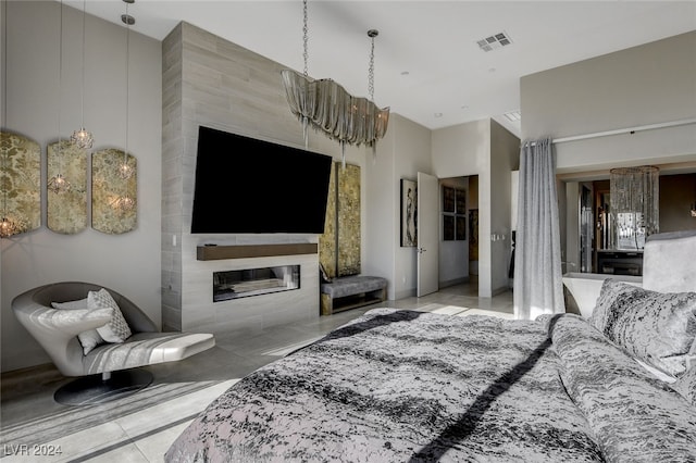 living room featuring a towering ceiling and a tiled fireplace