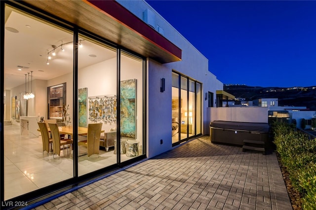 patio at twilight with a hot tub