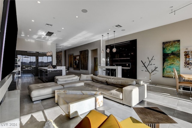 living room featuring light tile patterned flooring and sink