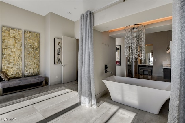 bathroom with tile patterned floors, a tub, and vanity