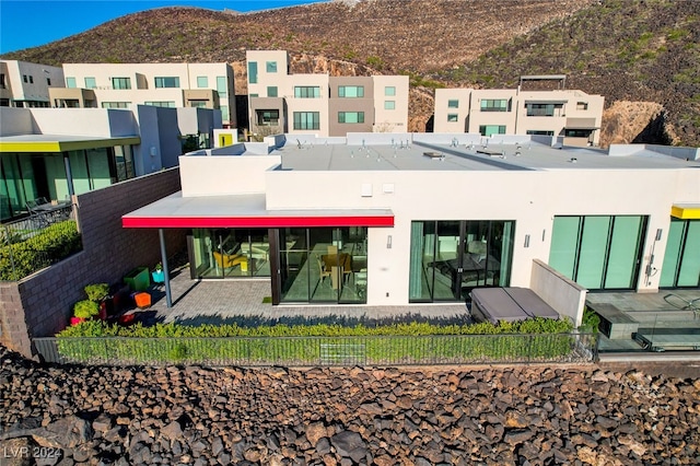 back of house with a mountain view