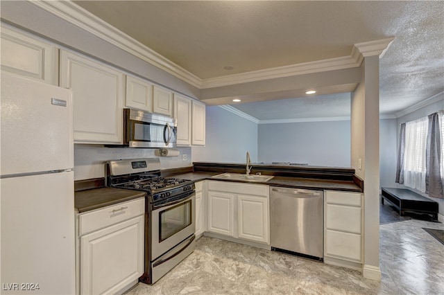 kitchen featuring sink, crown molding, white cabinetry, appliances with stainless steel finishes, and a textured ceiling