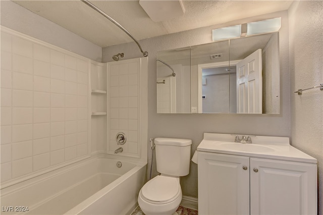 full bathroom featuring tiled shower / bath, vanity, toilet, and a textured ceiling