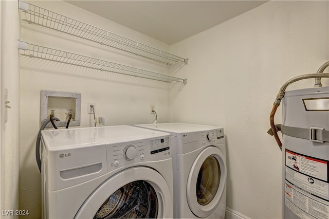 washroom featuring washing machine and dryer and water heater