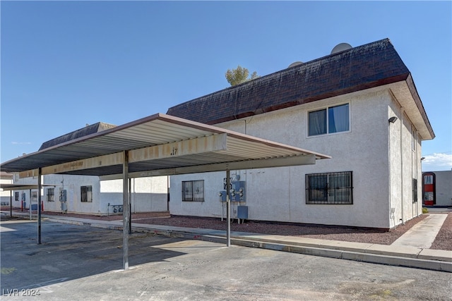 view of vehicle parking with a carport