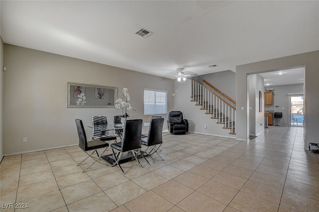 dining room with light tile patterned flooring, a wealth of natural light, and ceiling fan