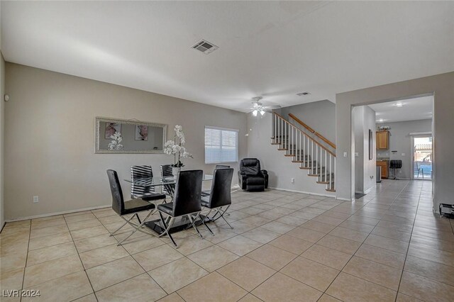 dining area featuring light tile patterned floors, a wealth of natural light, stairway, and visible vents