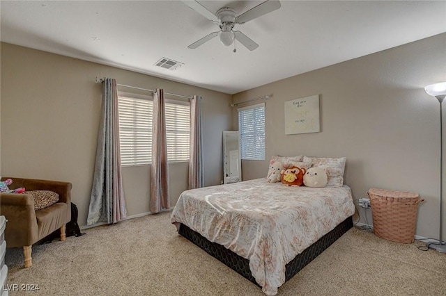 bedroom with ceiling fan, visible vents, and carpet floors